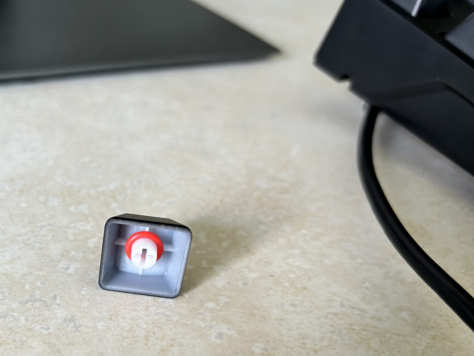 single keycap with a rubber o-ring pushed onto the post on the underside of the keycap