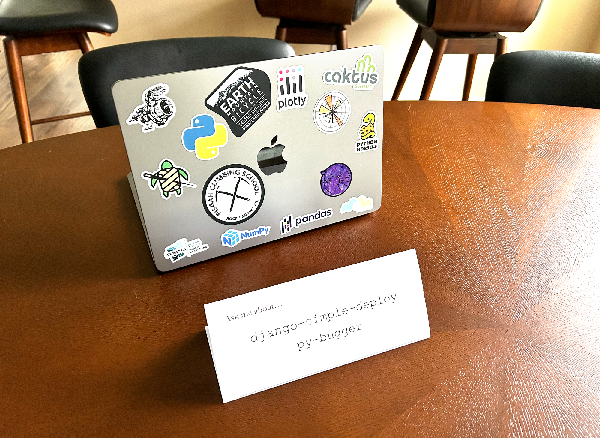placard reading "Ask me about... django-simple-deploy | py-bugger", in front of my laptop